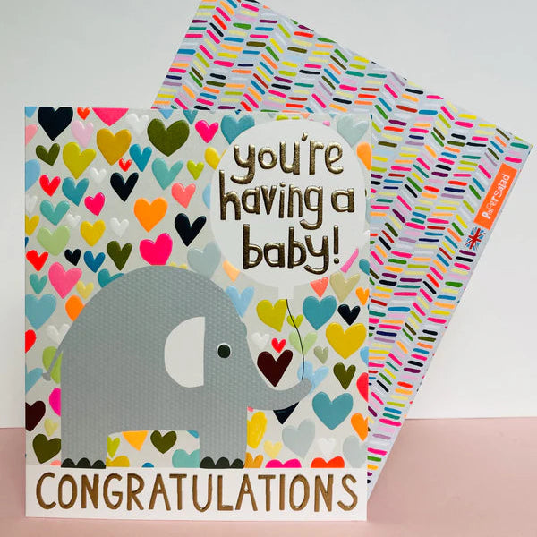 A greeting card with an illustration of an elephant and multicolored hearts, with the text 'You're having a baby!' and 'CONGRATULATIONS' on the front.