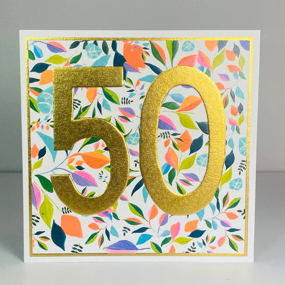 A 50th birthday card with a jumbo size, featuring a colorful patterned design, deep emboss, and bright neon colors, finished with gold foil and a large golden number '50' in the center.