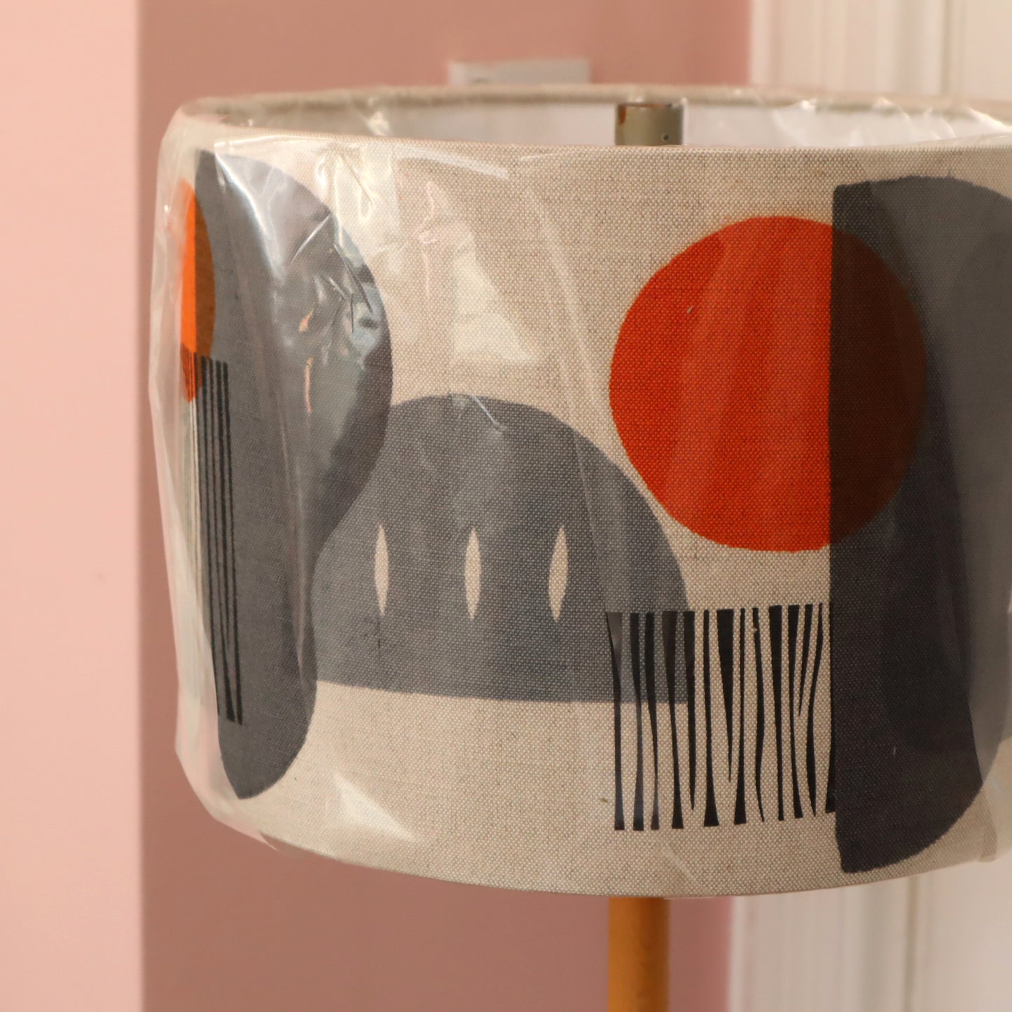 Decorative lampshade with abstract design on a pink background