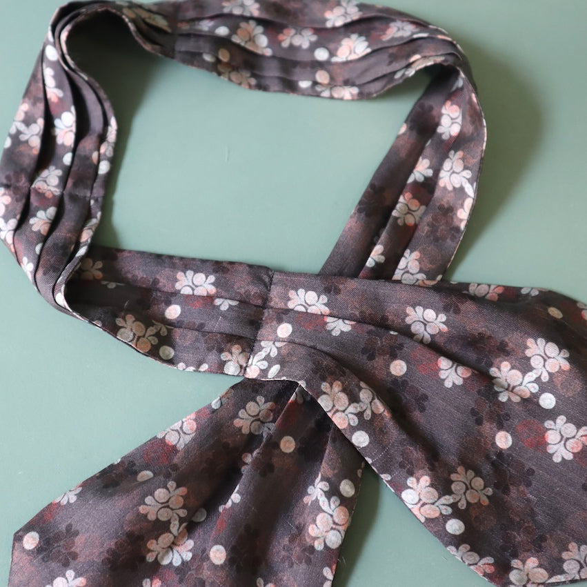Floral patterned scarf on a light green background