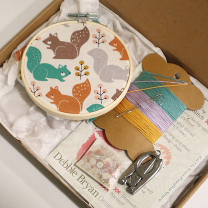 Embroidery hoop with animal pattern in a box with sewing supplies