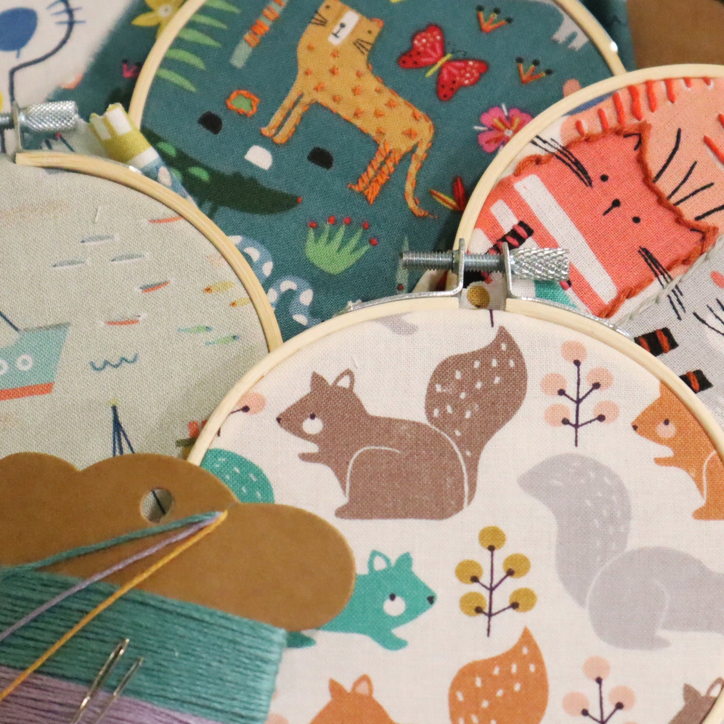 Set of embroidery hoops with animal-themed fabric patterns