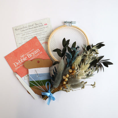Contents of a dried flower embroidery craft kit which includes Nottingham Lace tulle in an embroidery hoop, dried flower bunch, embroidery threads and how-to instructions