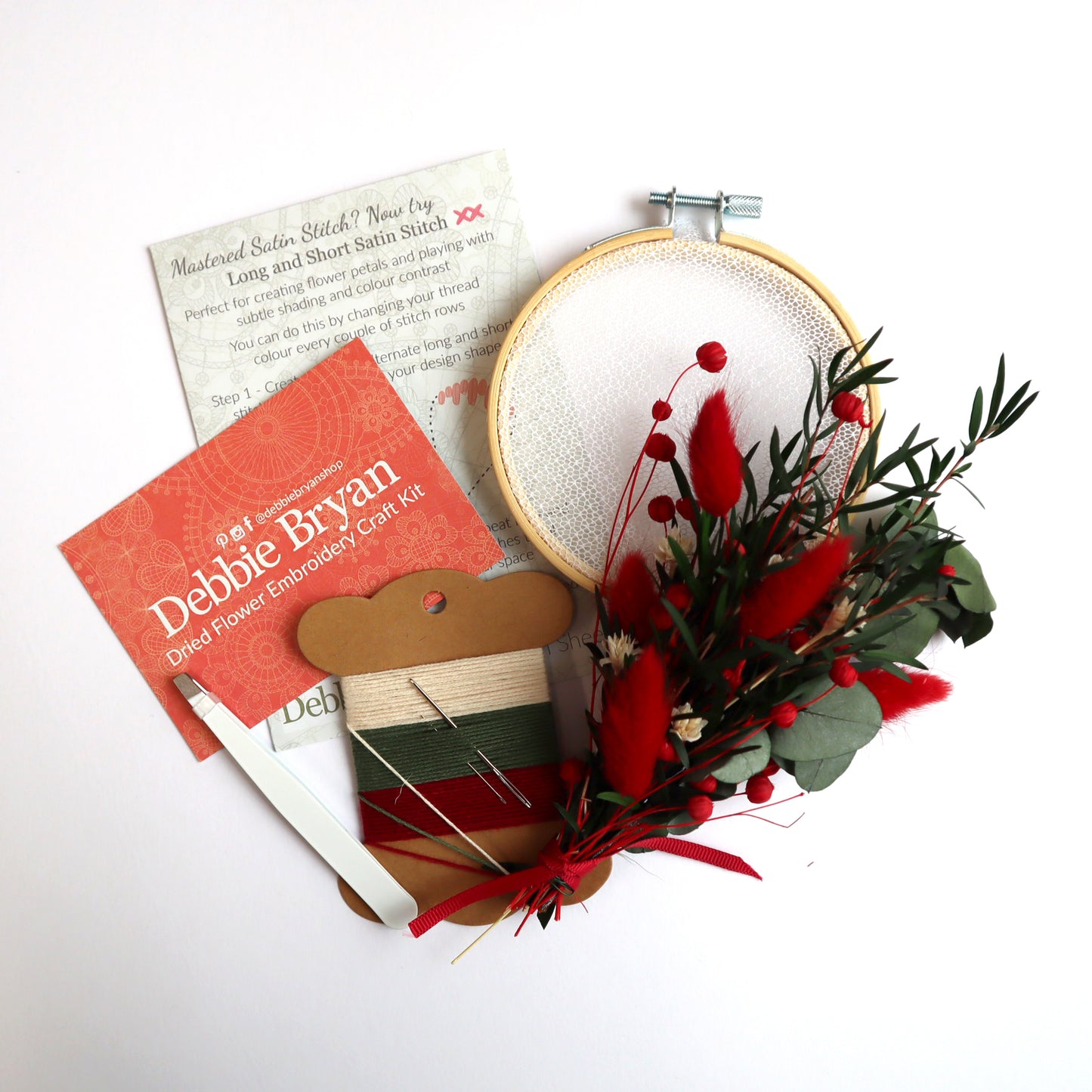 Contents of a dried flower embroidery craft kit which includes Nottingham Lace tulle in an embroidery hoop, dried flower bunch, embroidery threads and how-to instructions