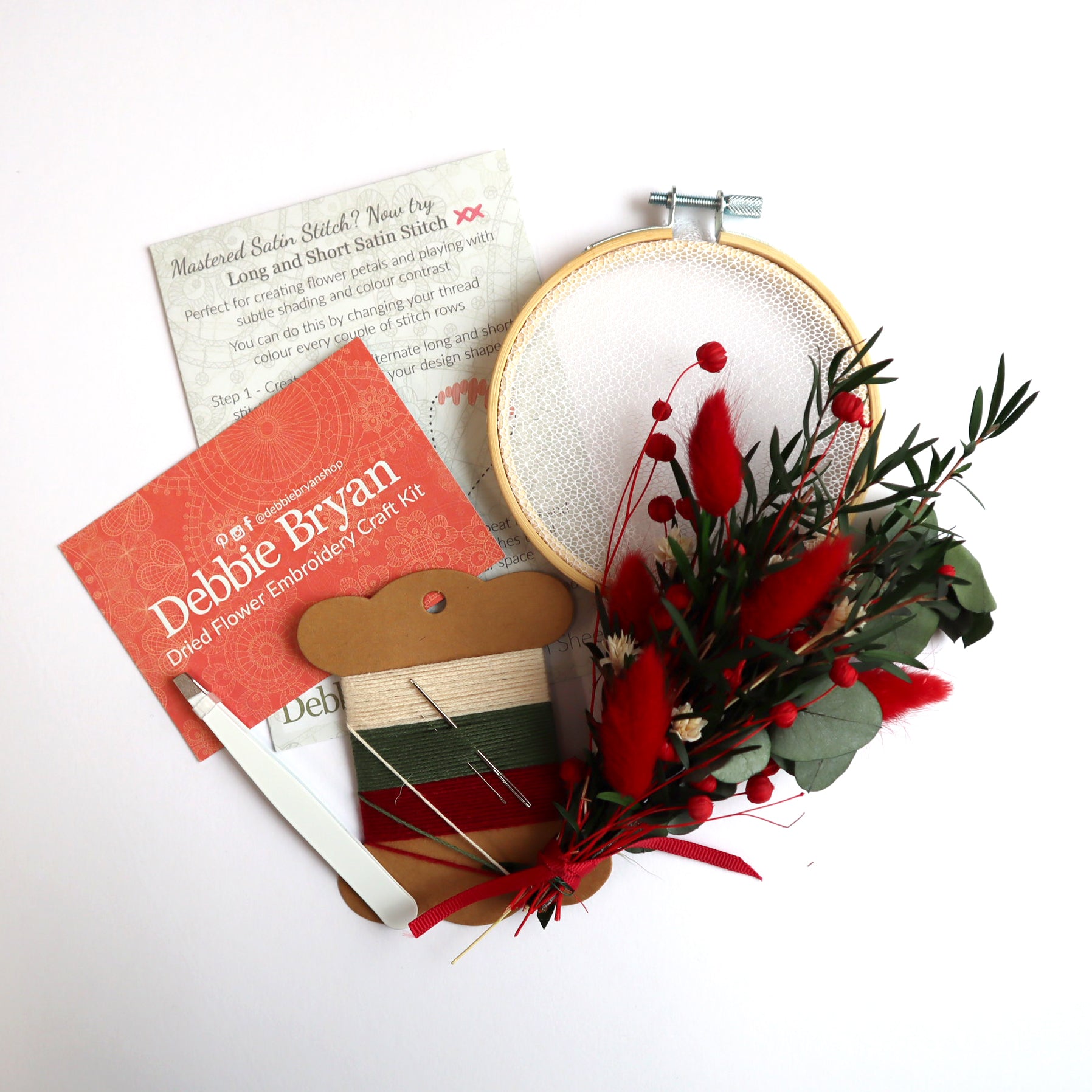Contents of a dried flower embroidery craft kit which includes Nottingham Lace tulle in an embroidery hoop, dried flower bunch, embroidery threads and how-to instructions