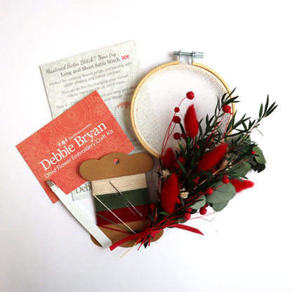 Contents of a dried flower embroidery craft kit which includes Nottingham Lace tulle in an embroidery hoop, dried flower bunch, embroidery threads and how-to instructions