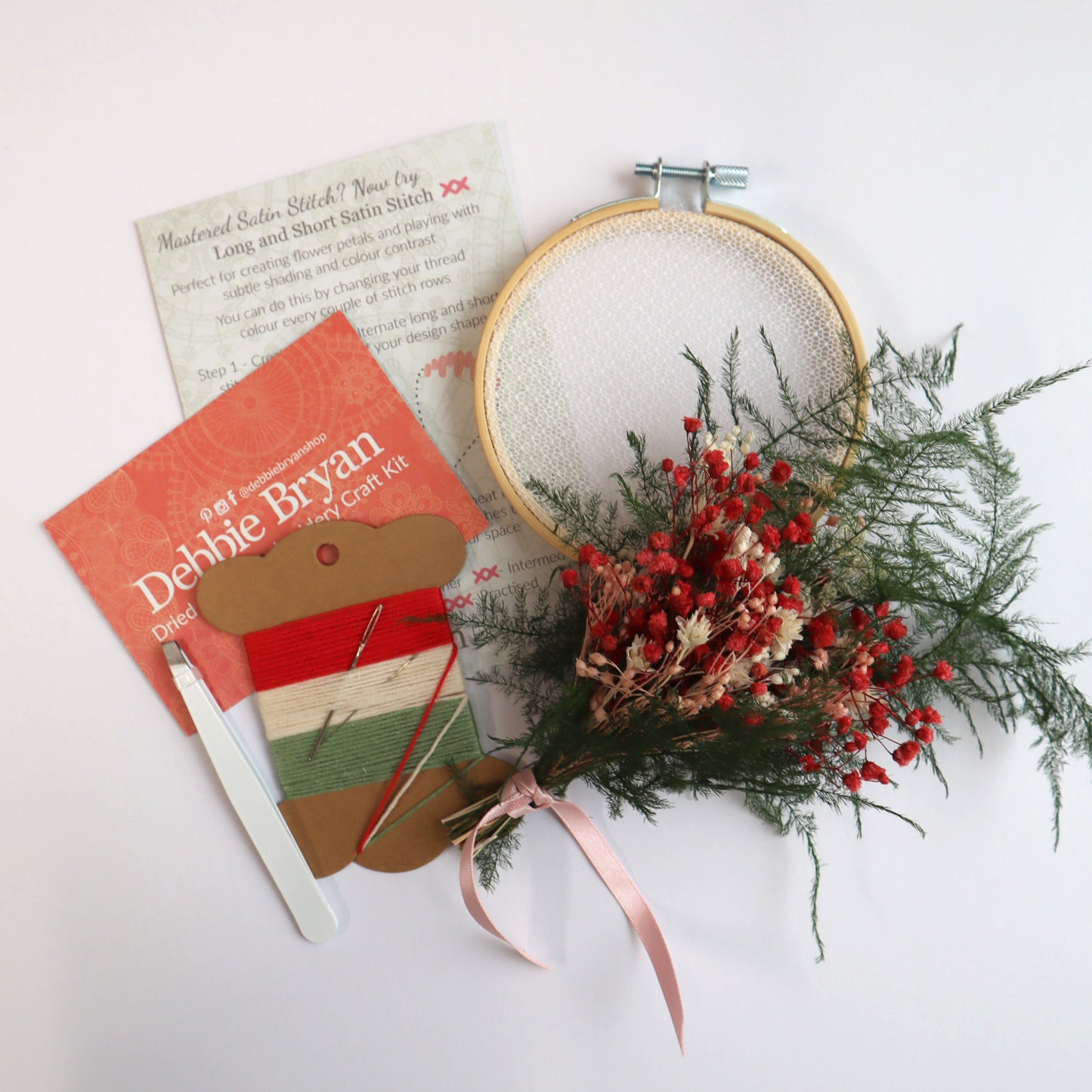 Contents of a dried flower embroidery craft kit which includes Nottingham Lace tulle in an embroidery hoop, dried flower bunch, embroidery threads and how-to instructions
