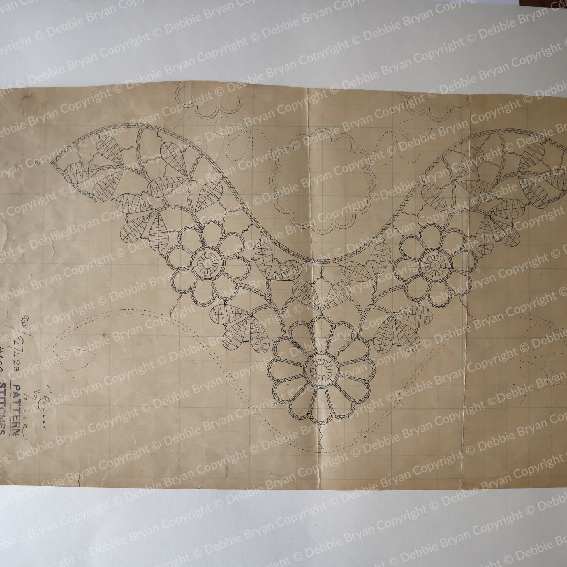 Design of a floral pattern on brown paper with 'Debbie Bryan' branding.