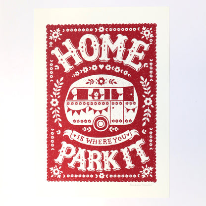 Decorative print with a red border and white text featuring a caravan illustration.