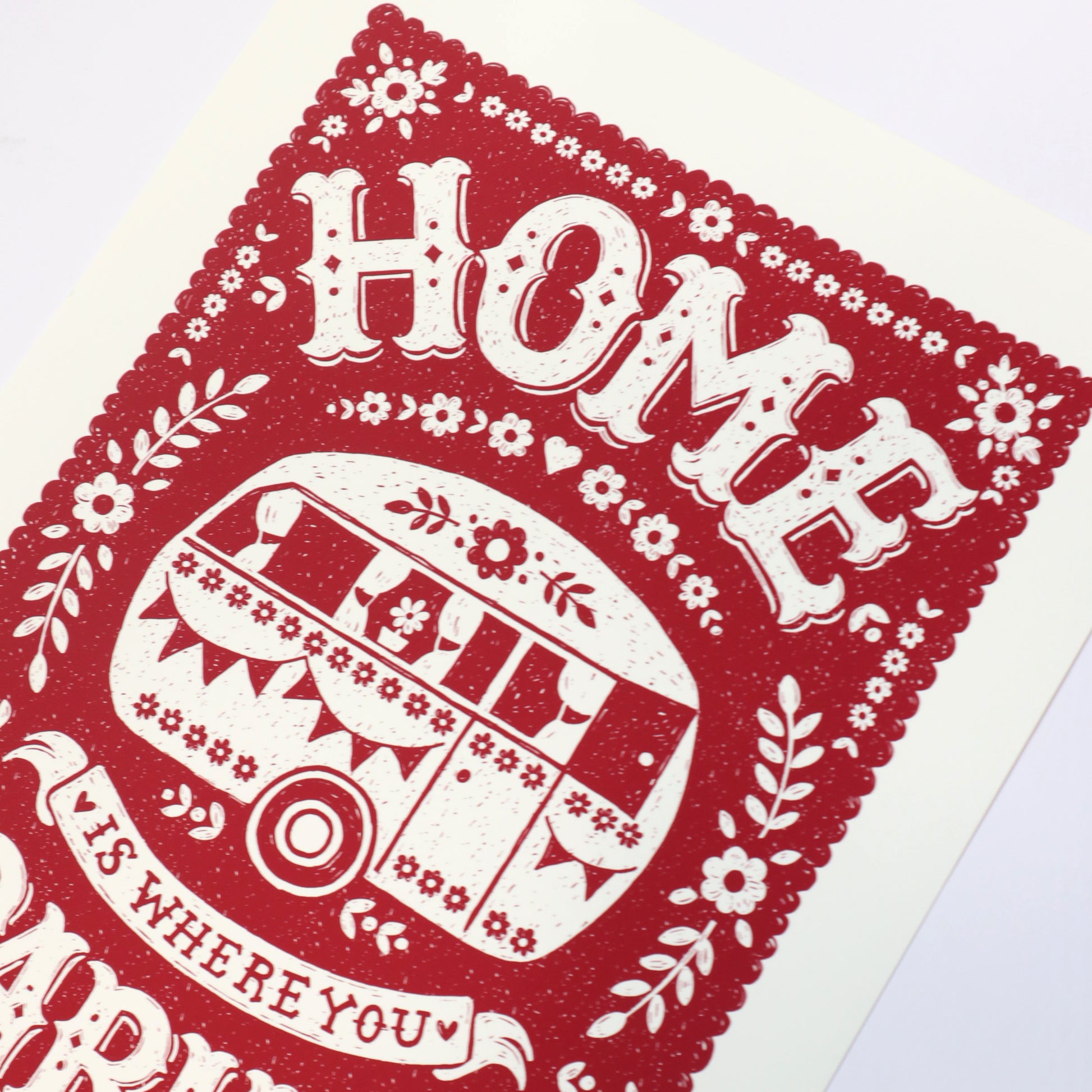 Decorative print with 'HOME is where you park it' text and red and white design.