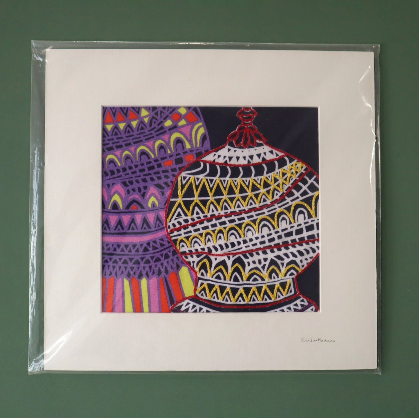 Colorful abstract art print of a vase in a clear plastic sleeve on a green background
