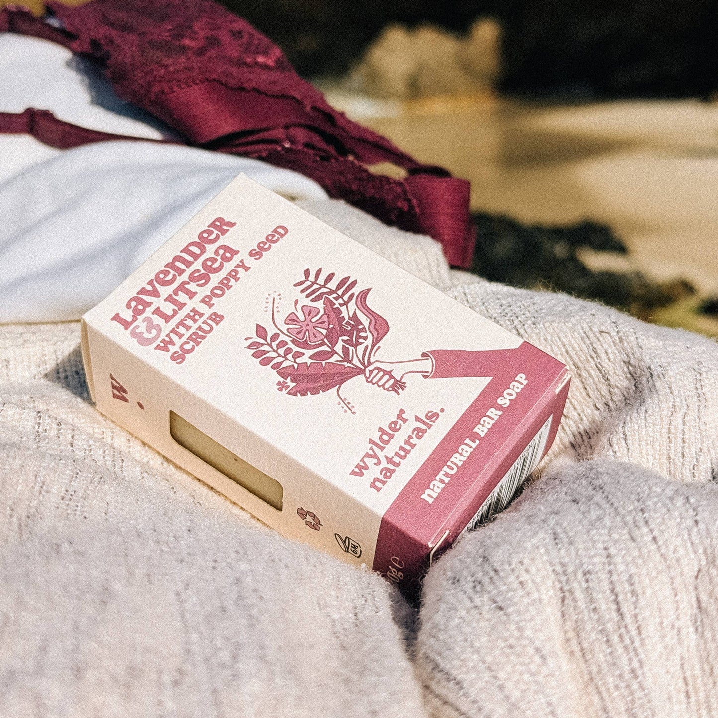 Lavender and litsea soap in branded box sitting on grey lined fabric