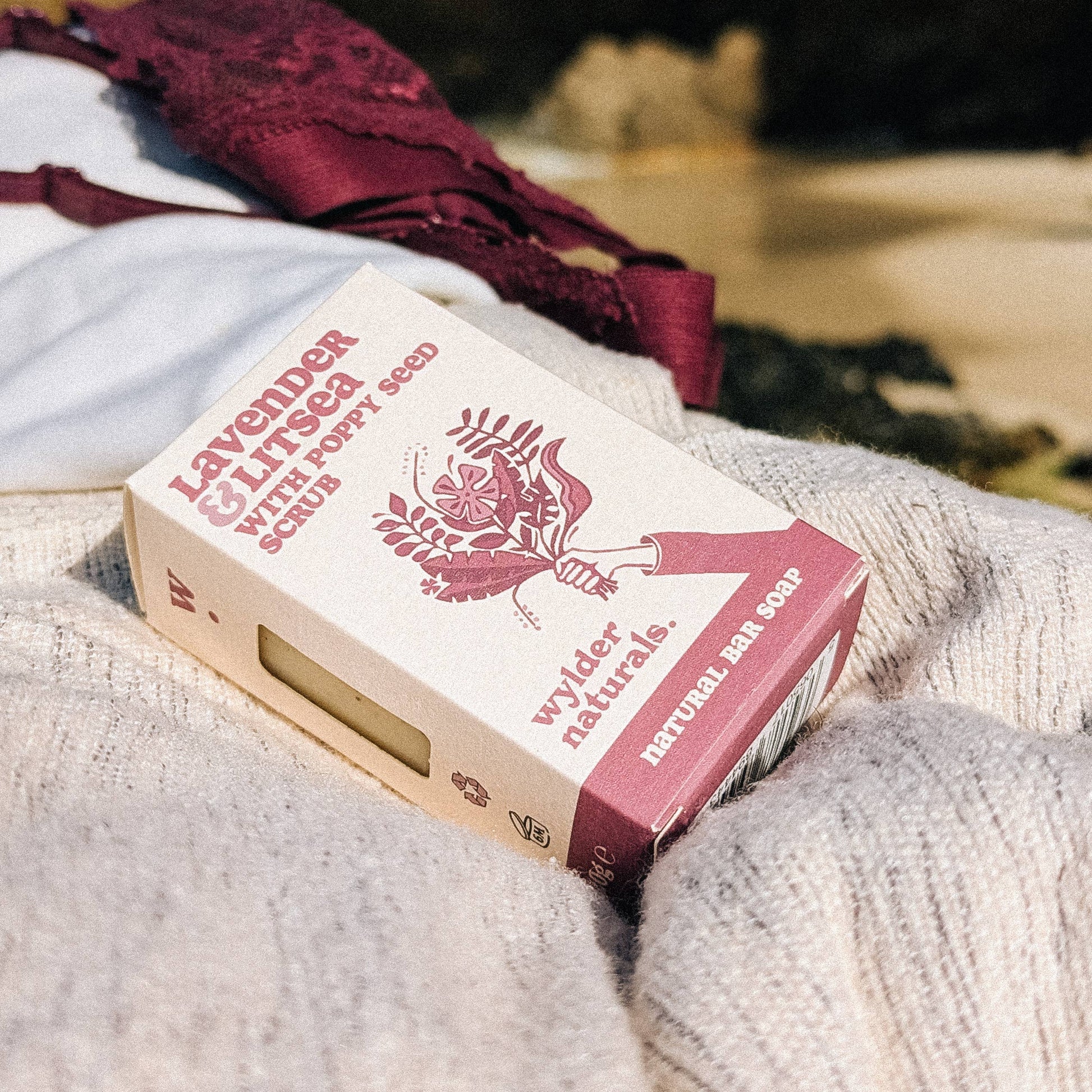 Lavender and litsea soap in branded box sitting on grey lined fabric