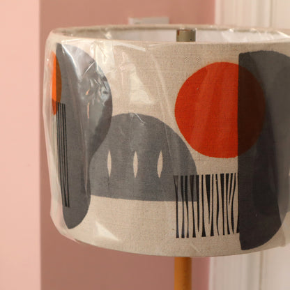 Decorative lampshade with abstract design on a pink background