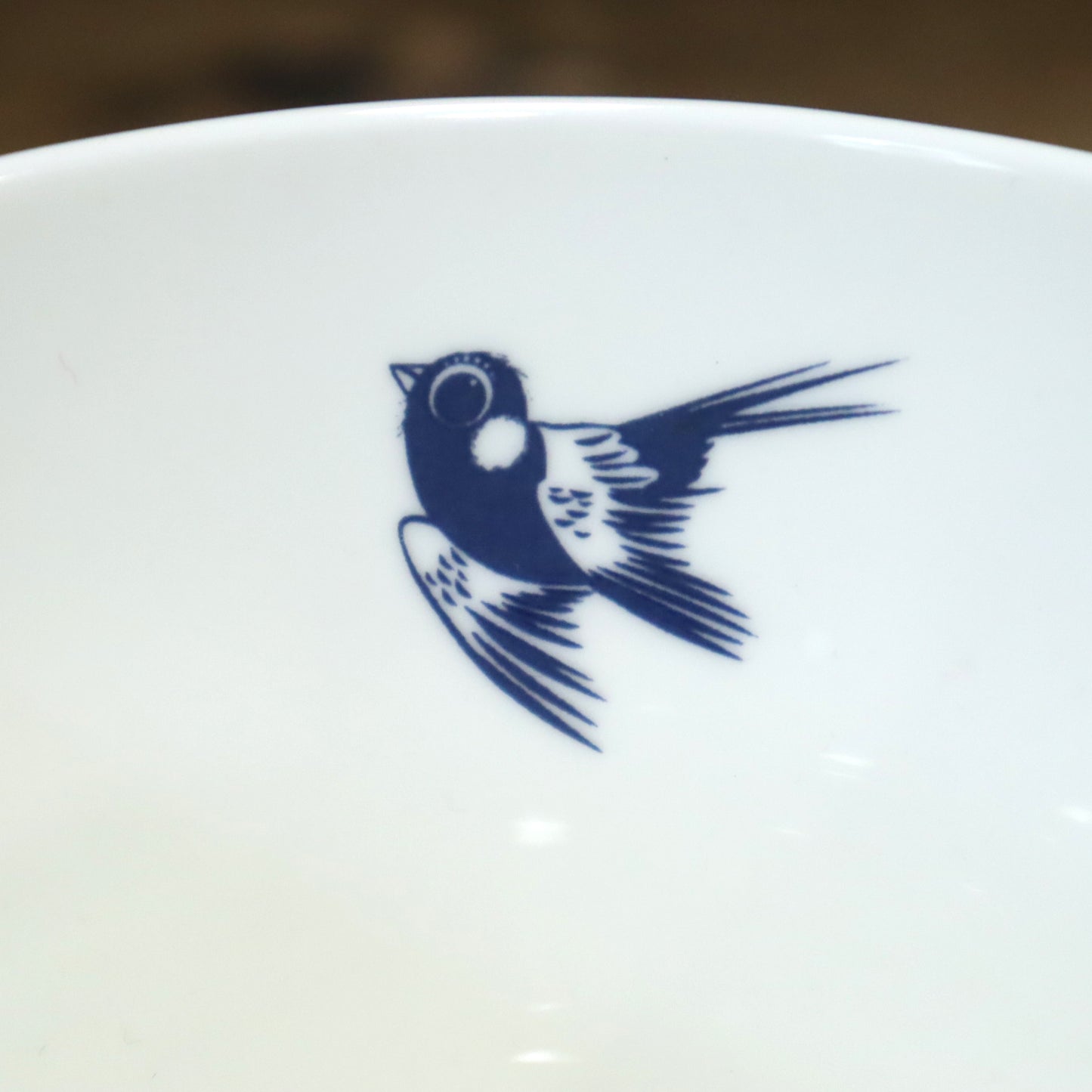 White ceramic plate with a blue bird design on a blurred background