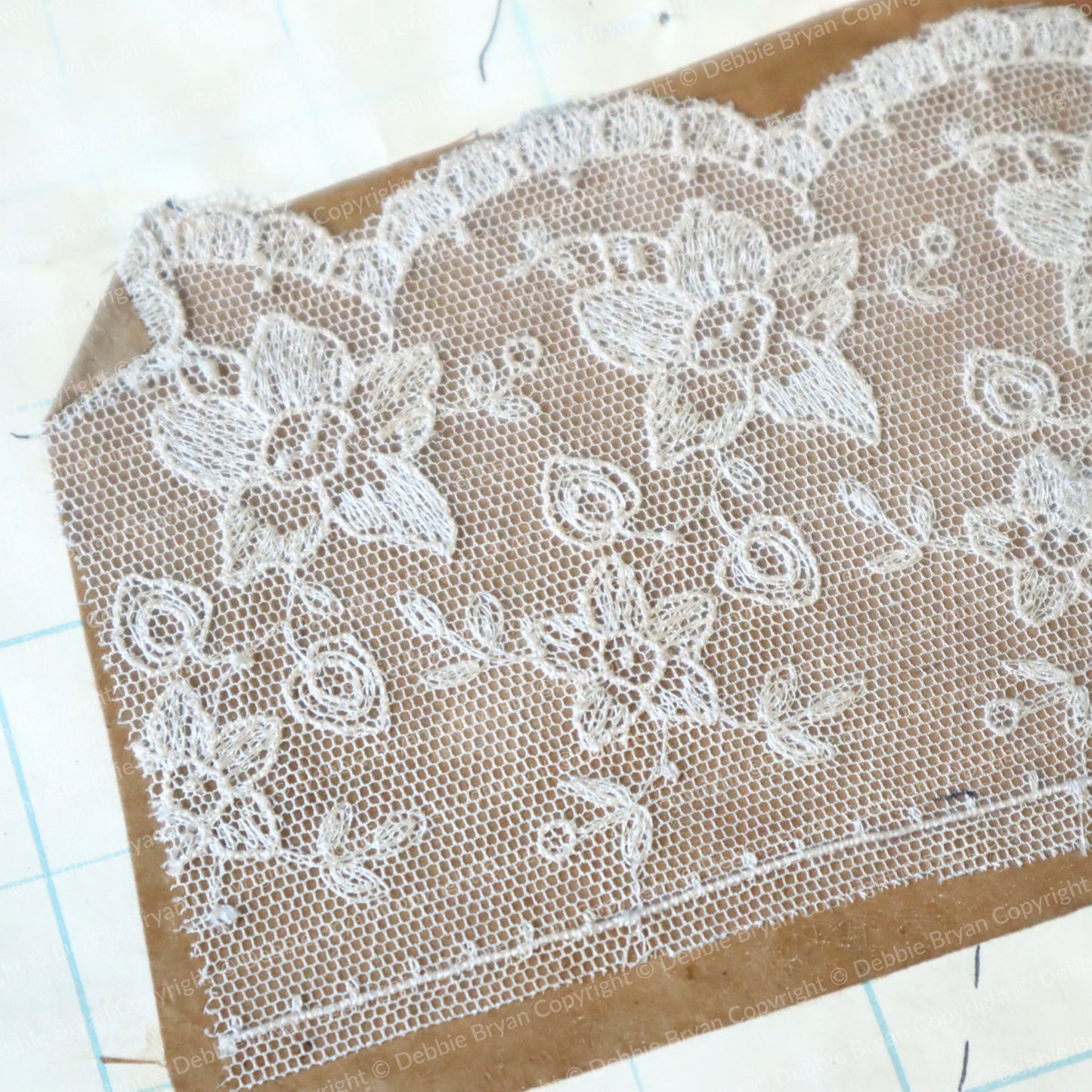 White lace fabric on a cardboard background