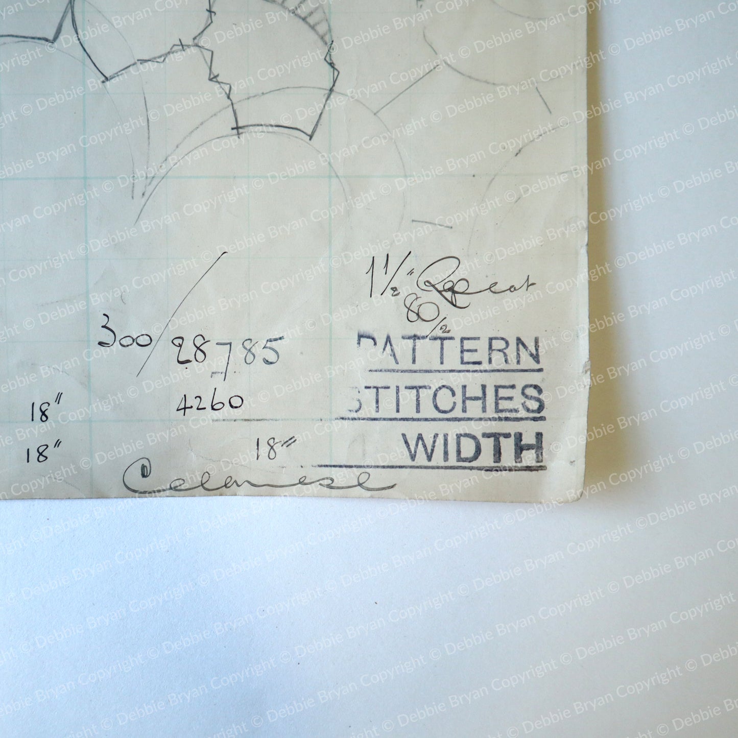 Paper with lace patterns and measurements on a white background