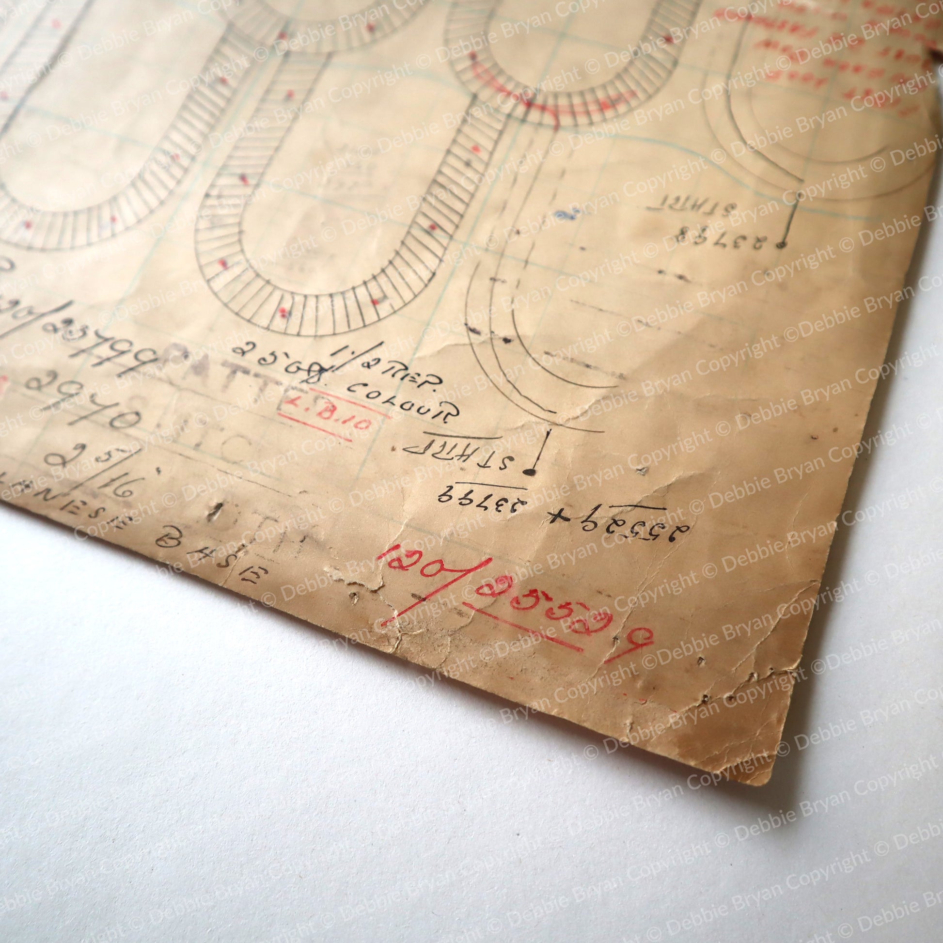 Close-up of an old document with handwritten notes and diagrams on a white background