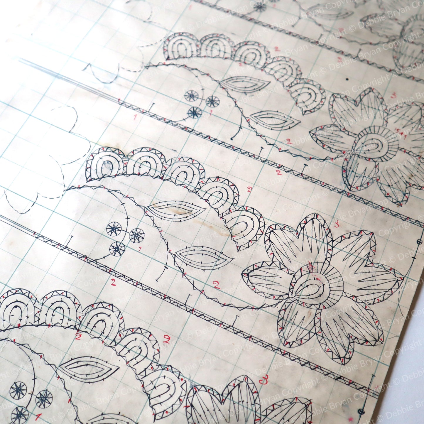 Vintage lace pattern with measurements and designs on a white background