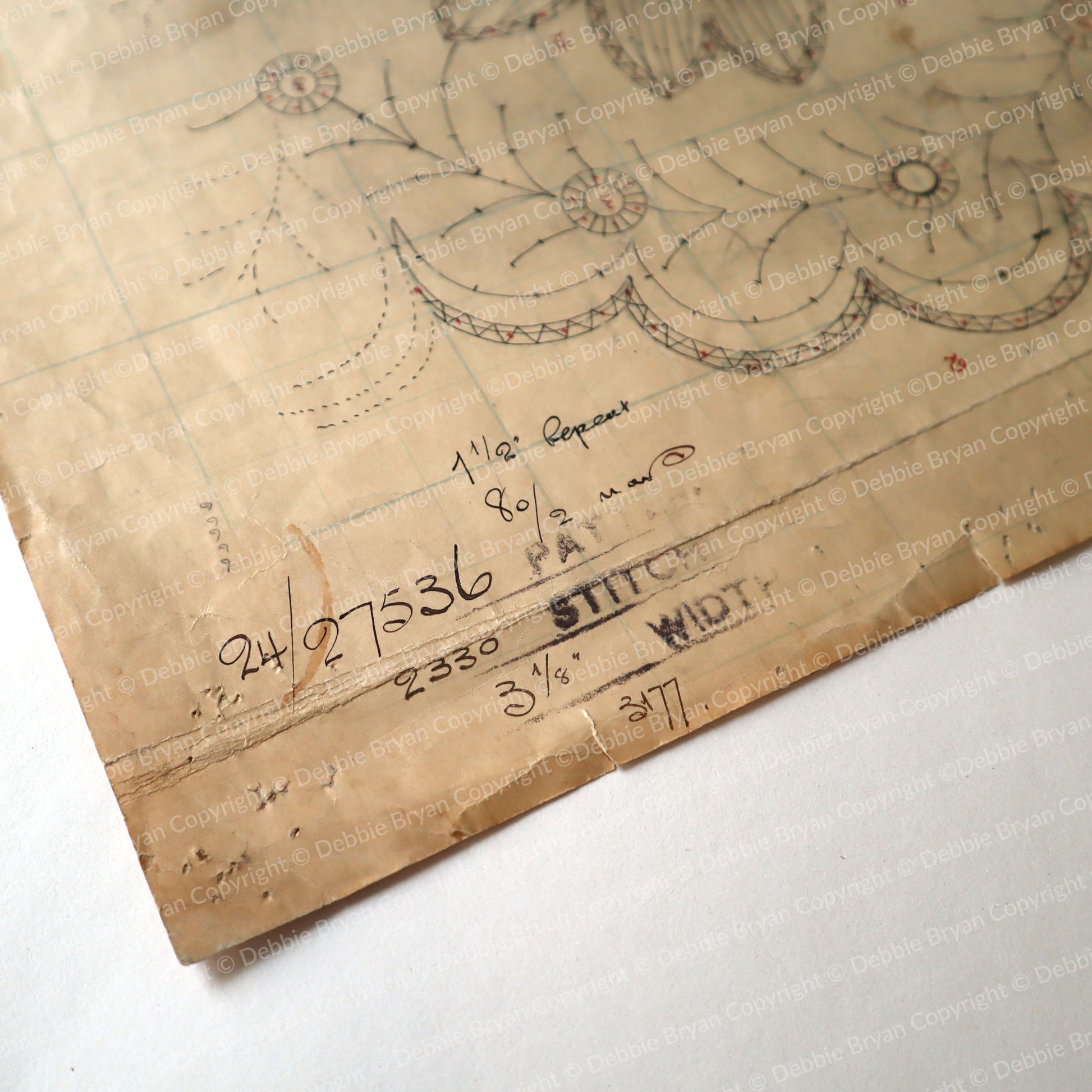 Vintage lace drawing on brown paper with measurements and text.