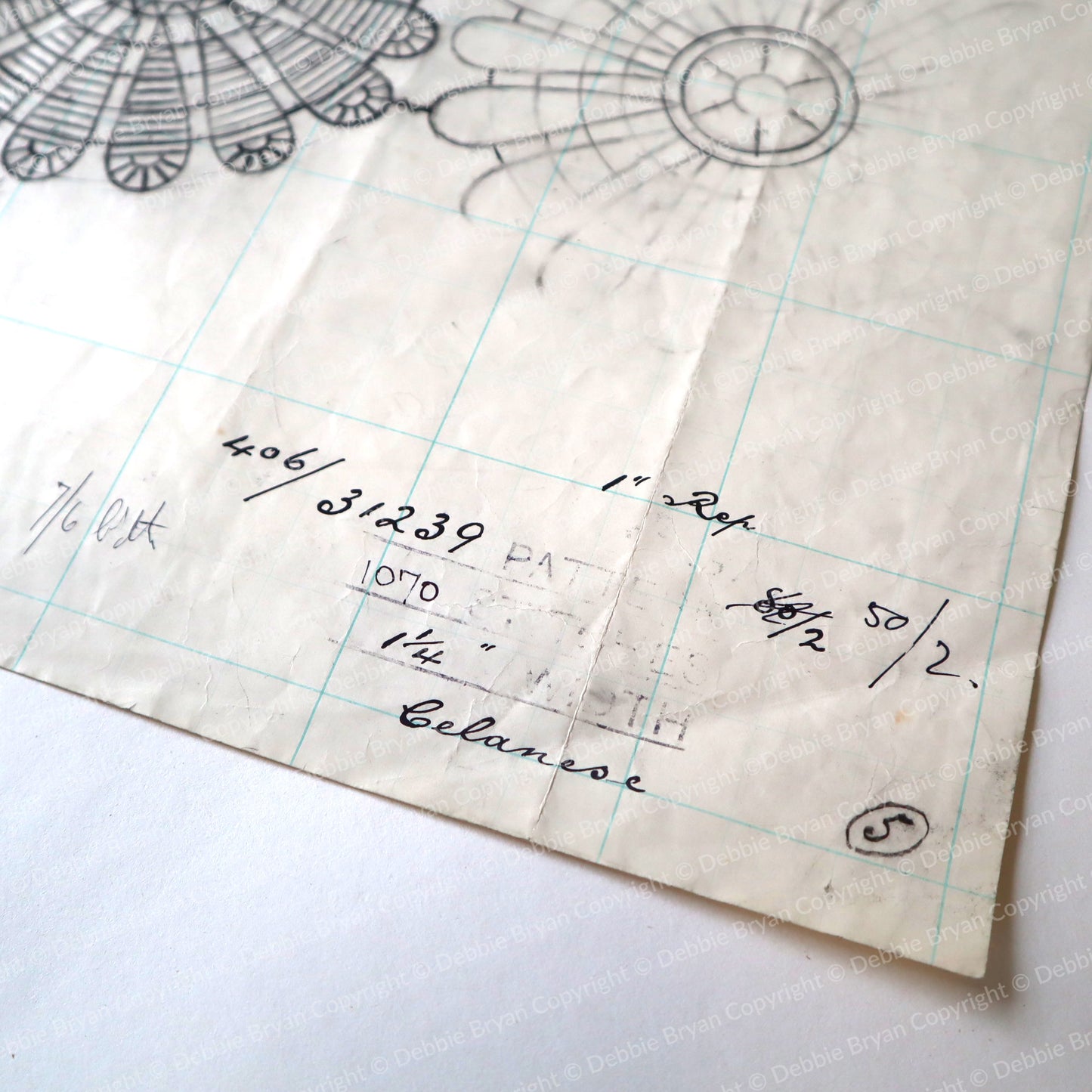 Vintage lace pattern with grid lines and handwritten notes on a white background