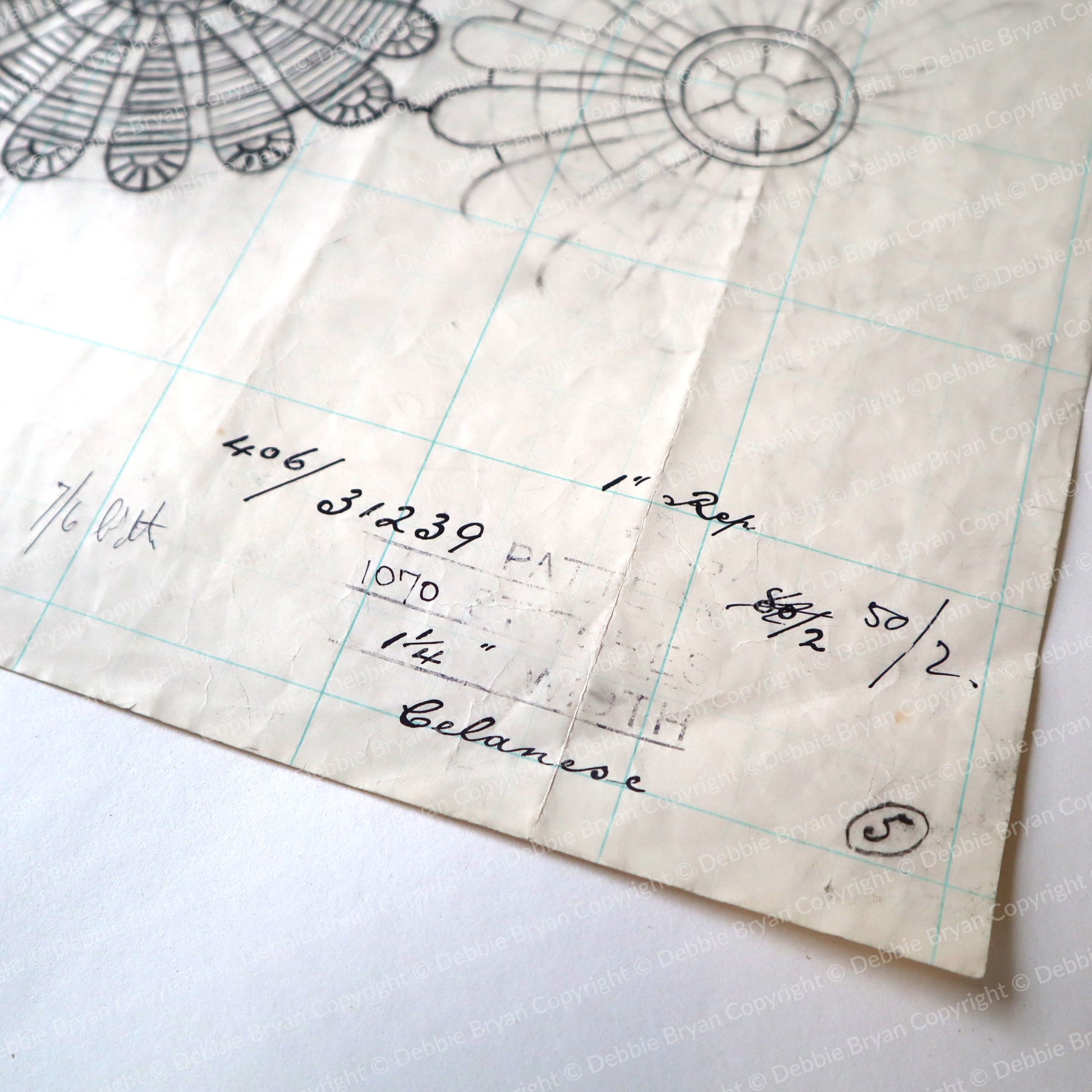 Vintage lace pattern with grid lines and handwritten notes on a white background