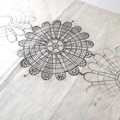Detailed black line drawing of a mandala on grid paper