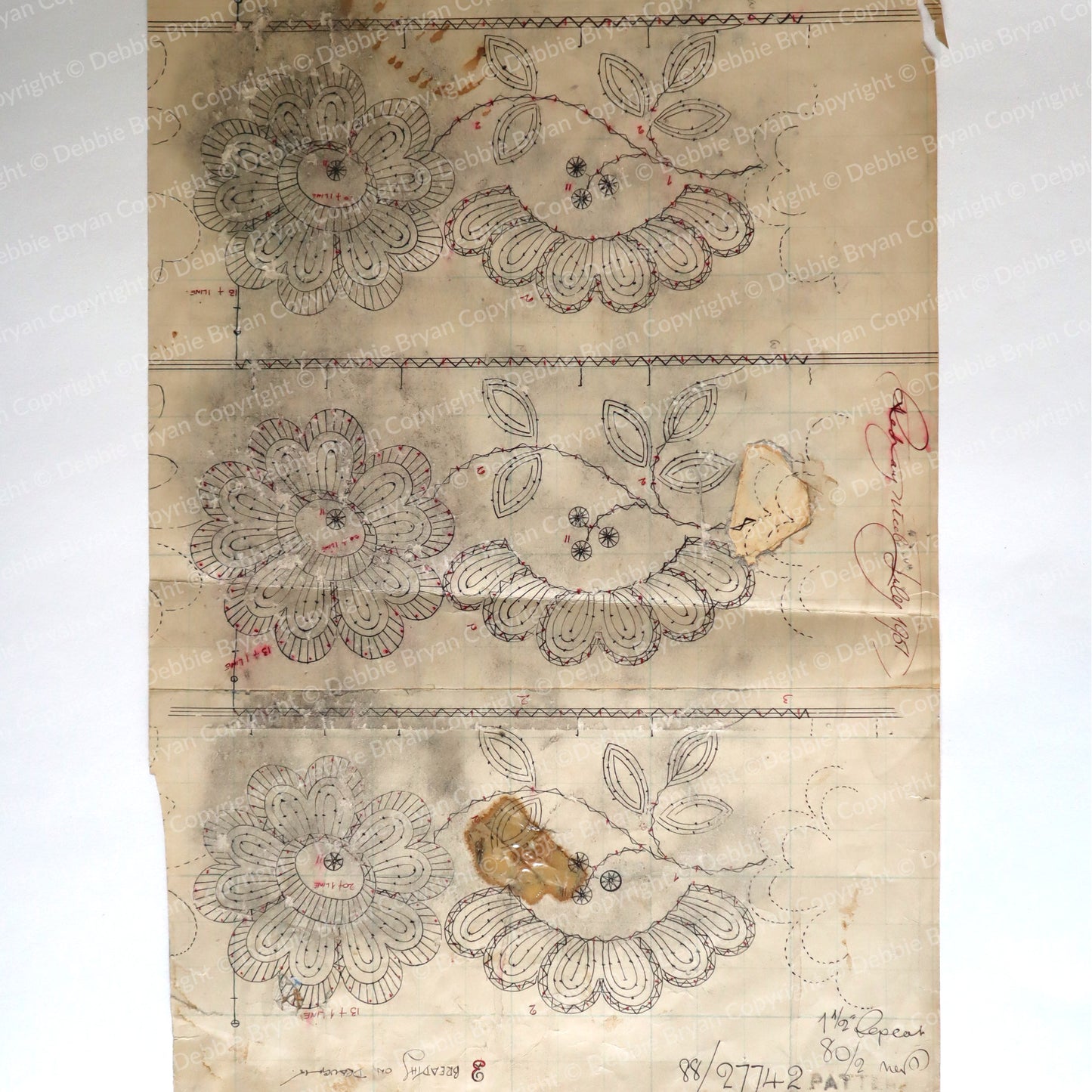 Sheet of paper with floral lace designs on a plain background