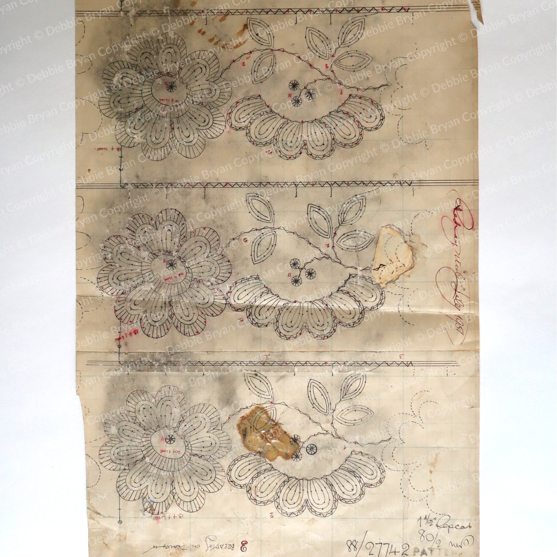 Sheet of paper with floral lace designs on a plain background