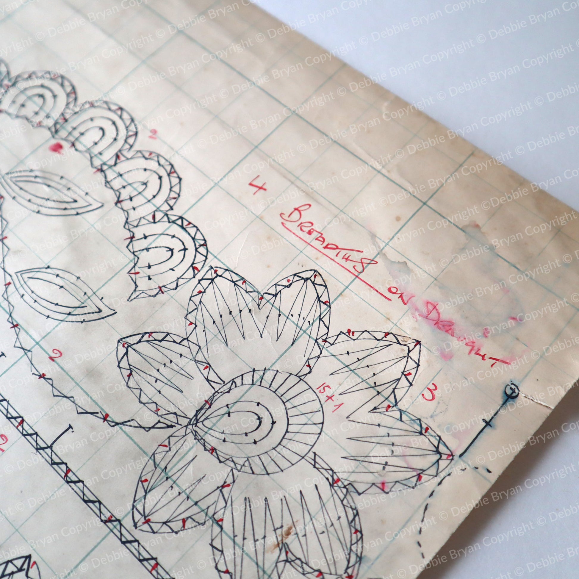 Vintage lace pattern with measurements and designs on a white background