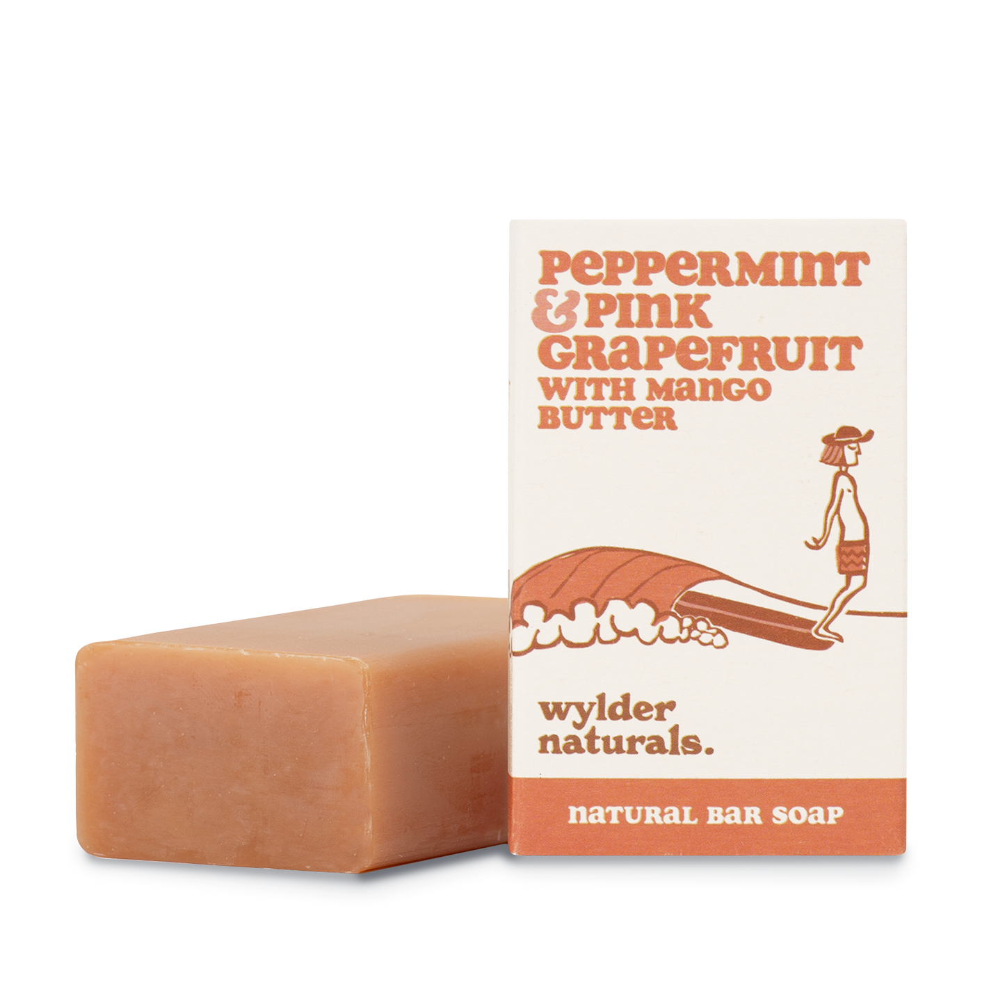 Peppermint and pink grapefruit soap packaging sitting next to a bar of soap