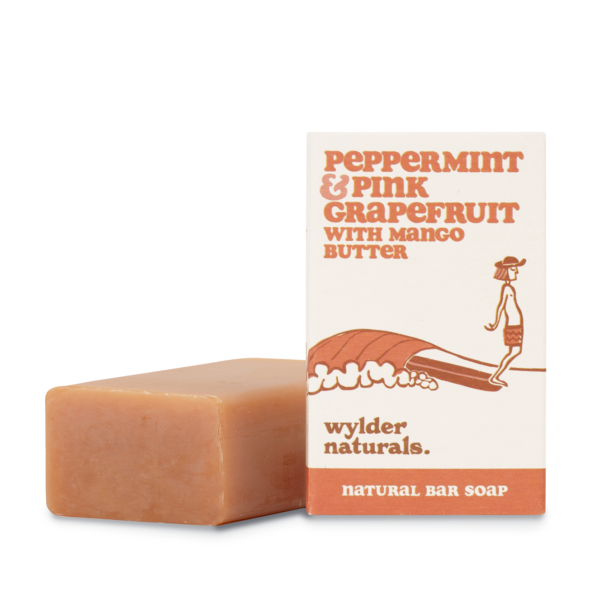 Peppermint and pink grapefruit soap packaging sitting next to a bar of soap