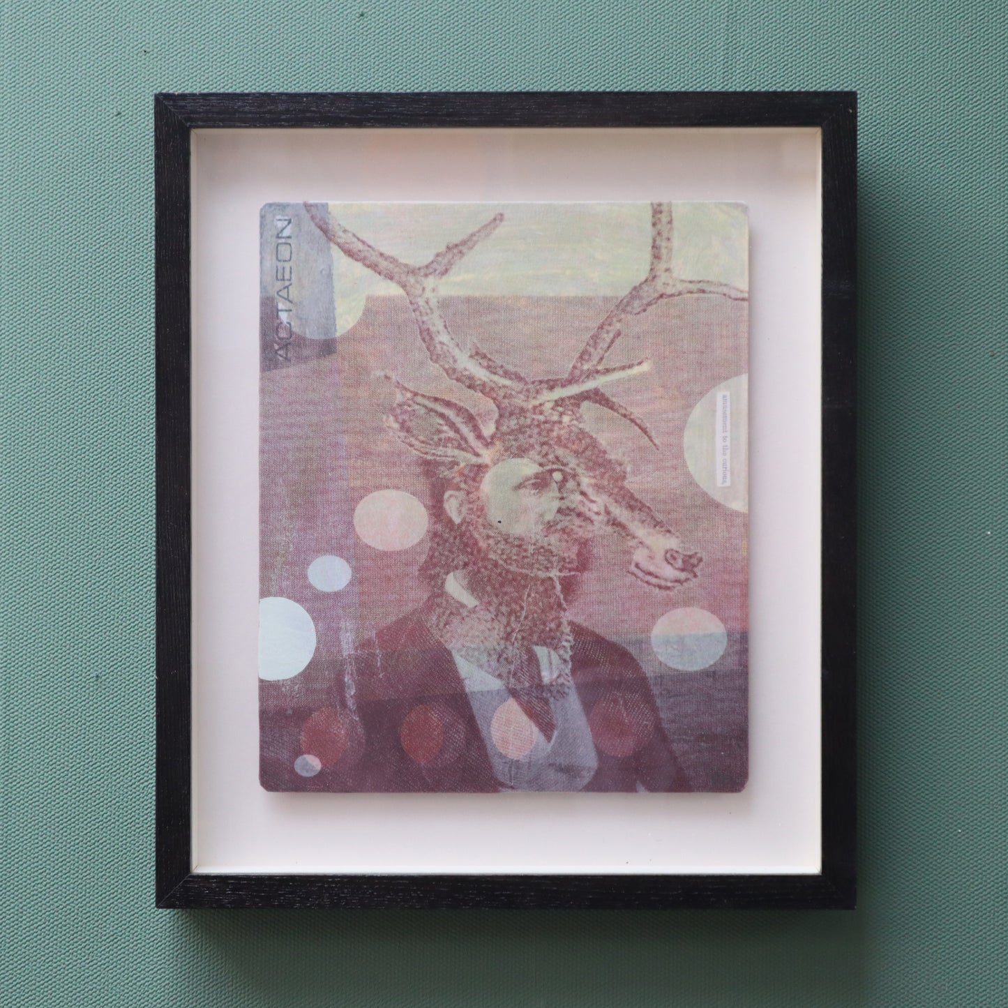 Framed artwork featuring a suited man with stags head