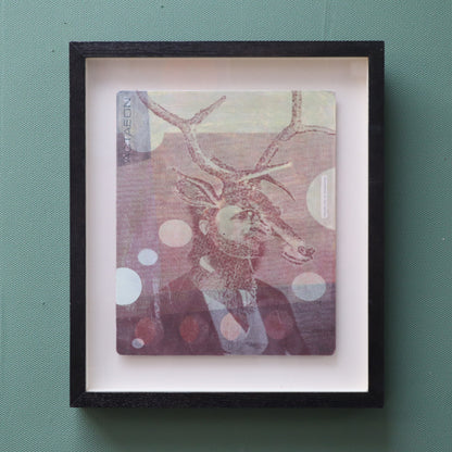 Framed artwork featuring a suited man with stags head