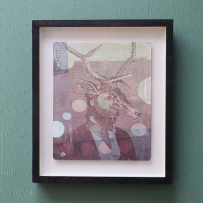 Framed artwork featuring a suited man with stags head