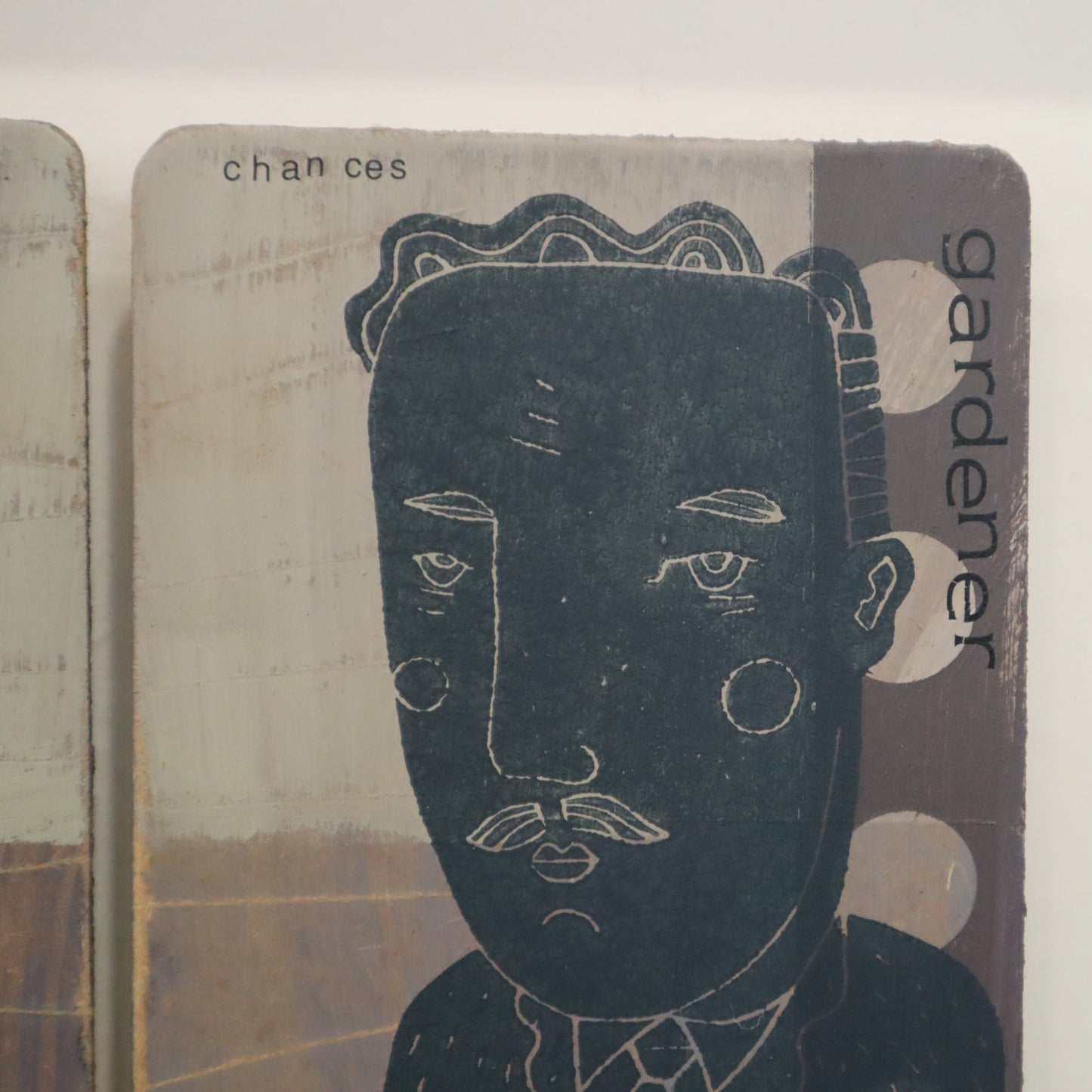 Illustration of a face on a card with text 'chances' and 'gardener' on a textured background.