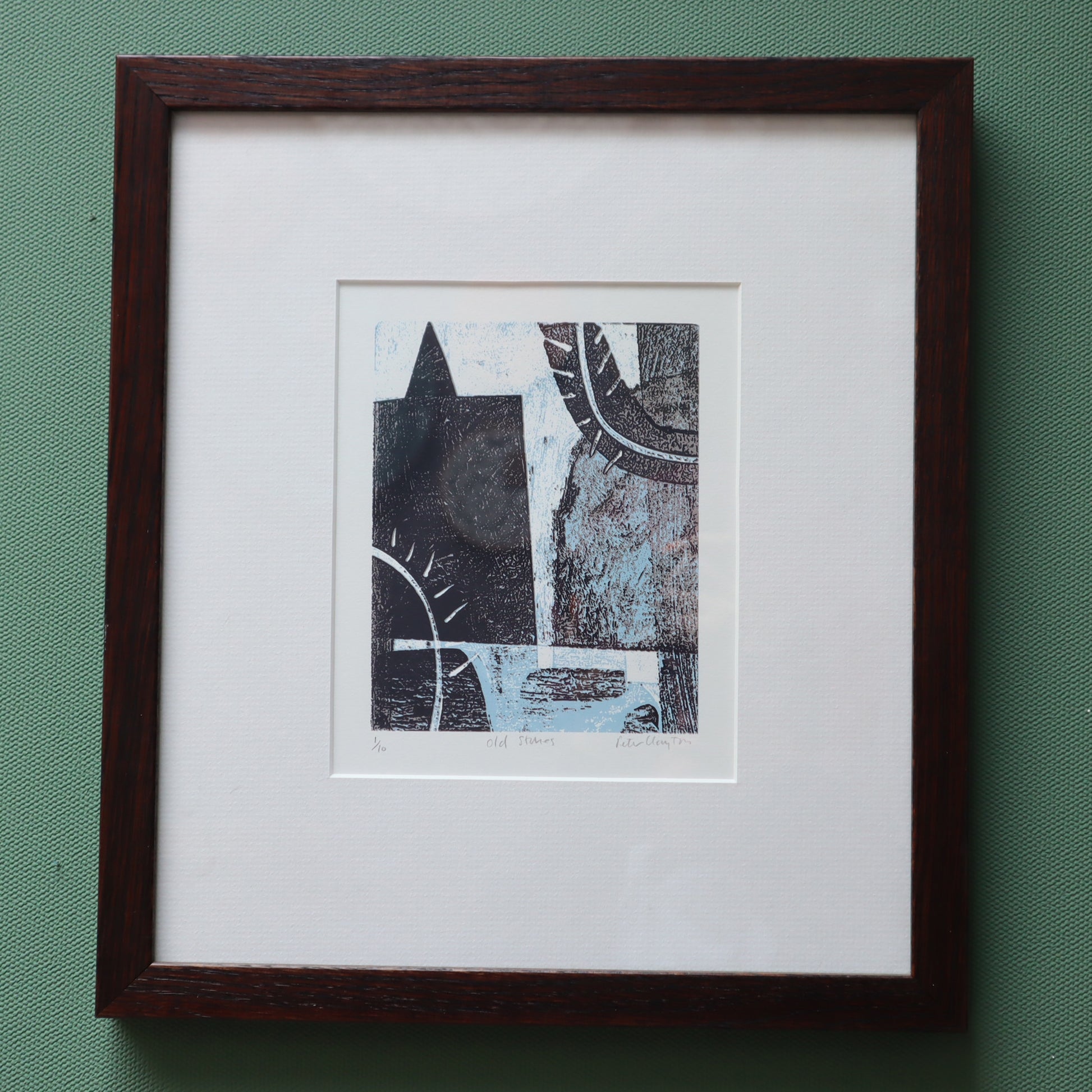 Framed abstract artwork on a green background