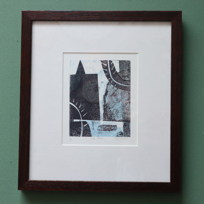 Framed abstract artwork on a green background