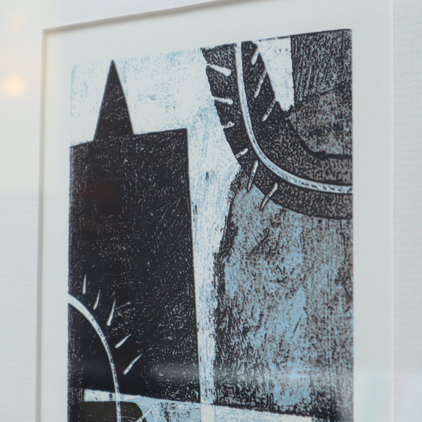 Abstract black and blue artwork on a white wall