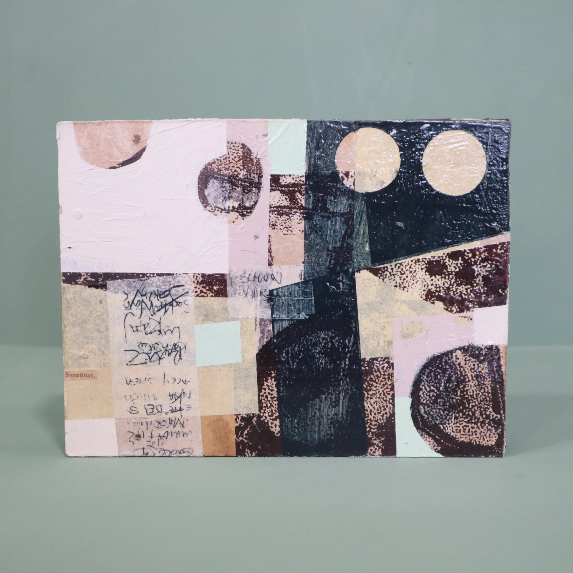 Abstract art piece with geometric shapes and text on a gray background