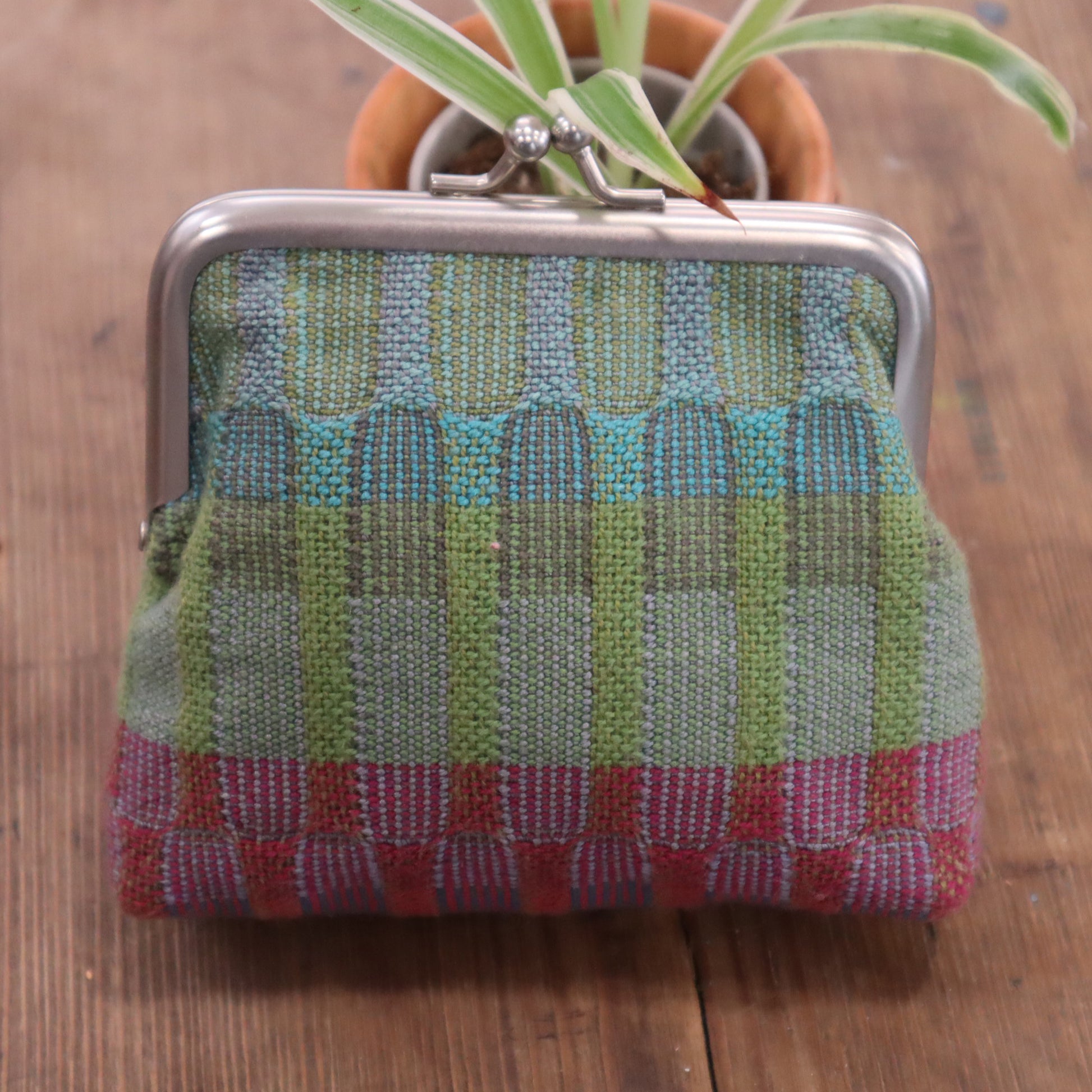 Textured fabric pouch with a checkered pattern on a wooden surface