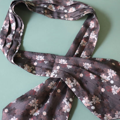 Floral patterned scarf on a light green background