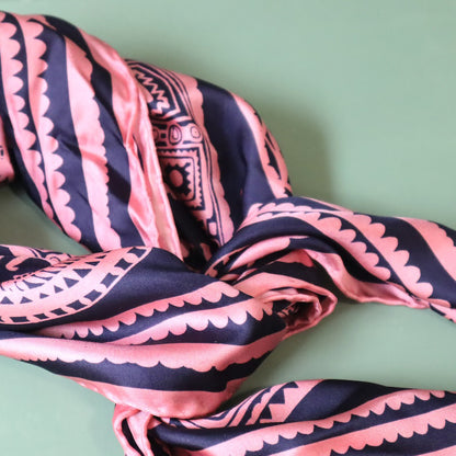 Pink and black patterned fabric on a green background