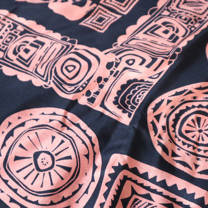 Close-up of pink tribal patterns on a dark fabric background