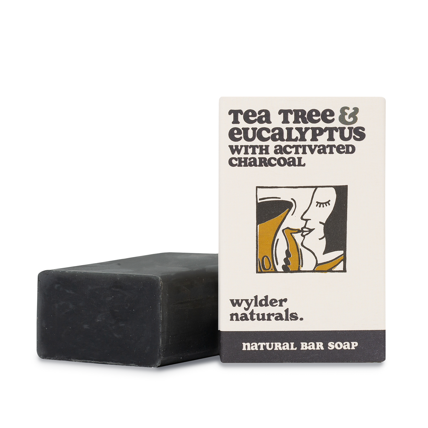 Tea tree and eucalyptus soap packaging next to black bar of soap
