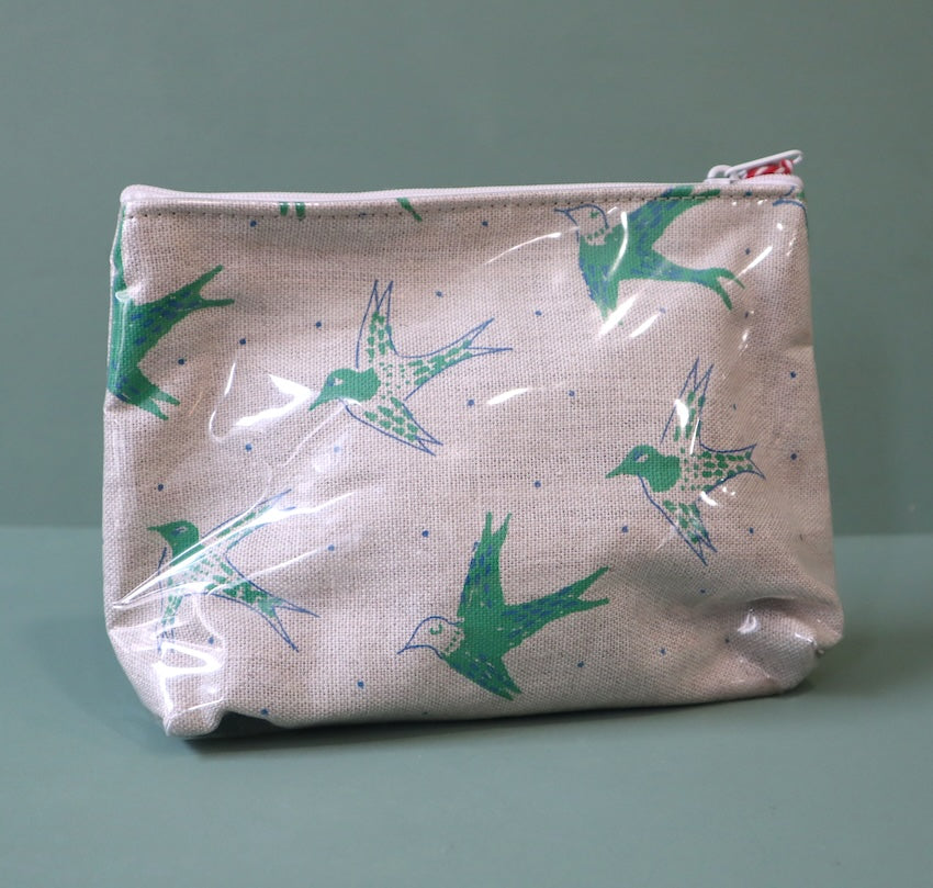 Linen washbag with plastic cover and a green  design of birds in flight. 