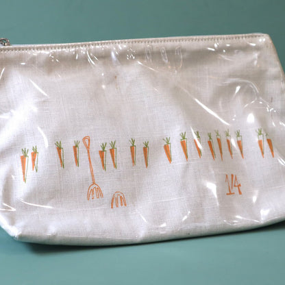 Linen washbag with plastic cover, the design shows a small row of orange carrots with a garden fork and 1'4