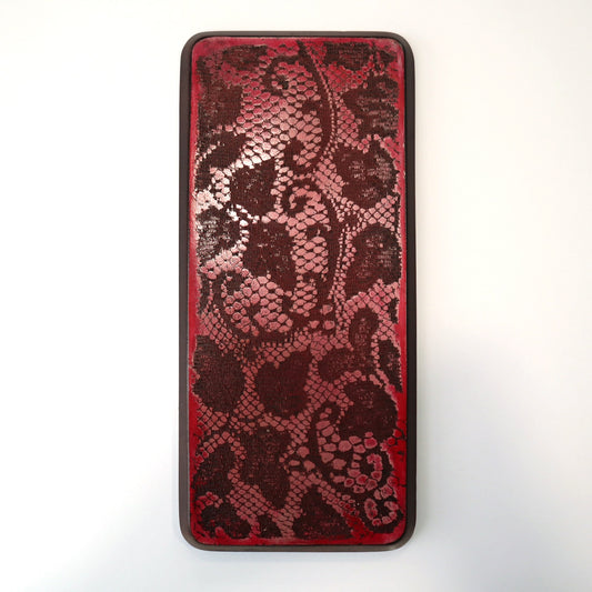 Red wall art with lace imprinted in