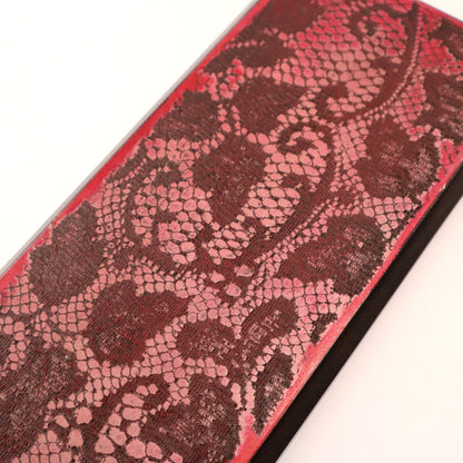 Close-up of a red and black patterned wall art