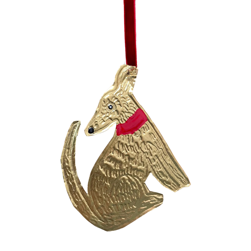 A tin embossing sitting dog ornament with a ribbon, featuring a hand-painted, unique enamel detail.